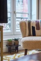 a living room with a chair and a window at Charmant cocon lyonnais Sathonay-Terreaux in Lyon