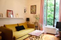 a living room with a yellow couch and a table at Chez Julie -métro Garibaldi- Université in Lyon