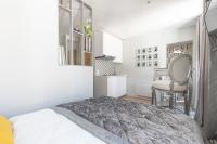 a bedroom with a bed and a table and a chair at Le Petit Prince- Studio cosy 2 pers -métro Valmy in Lyon