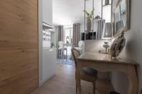 a kitchen and dining room with a table and a room at Le Petit Prince- Studio cosy 2 pers -métro Valmy in Lyon