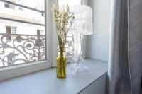 a yellow vase with flowers on a window sill at Le Petit Prince- Studio cosy 2 pers -métro Valmy in Lyon