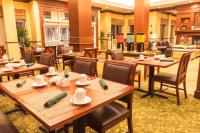 a dining room with wooden tables and chairs at Hilton Garden Inn Bangor in Bangor