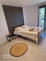 a bedroom with two beds and a rug at CHEZ LALLA in Marseille