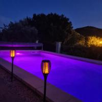 a swimming pool with purple lighting at night at Gîte spa la parenthèse in Sauve