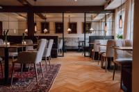 a restaurant with tables and chairs in a room at Schmidtburger Hof in Weiler