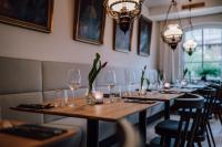 a row of tables in a restaurant with wine glasses at Schmidtburger Hof in Weiler