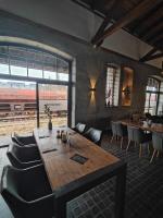 a dining room with a table and chairs and a train at Hostel am GÜTERBAHNHOF in Neubrandenburg