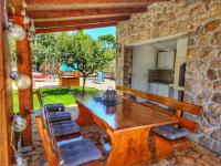 a wooden table and chairs on a patio at Villa Prima Natura, Imotski private pool in Imotski