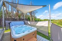 a hot tub in a gazebo on a deck at Le Theven in Sibiril