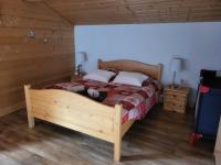 a bedroom with a wooden bed in a room at La petite Anfiane in Le Grand-Bornand