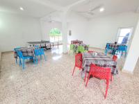 a group of tables and chairs in a room at Hotel Vista Laguna Bacalar in Bacalar