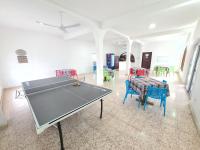a ping pong table in a room with chairs at Hotel Vista Laguna Bacalar in Bacalar