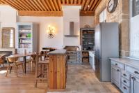 a kitchen with a table and a refrigerator at Le Cocon Pacôme Les Autres in Lyon