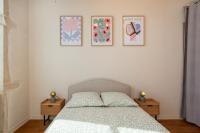 a bedroom with a bed and three pictures on the wall at Le Cocon Pacôme Les Autres in Lyon