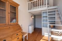 a room with a loft bed and a wooden cabinet at Le Cocon Pacôme Les Autres in Lyon