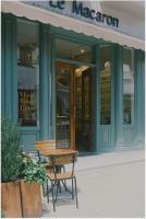 a table and chairs in front of a store at Le Macaron City Center - Boutique Hotel Đà Lạt in Da Lat