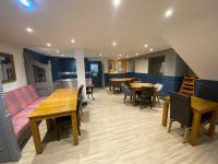 a living room with a couch and tables and chairs at Plas Coch Hotel Ltd in Bala