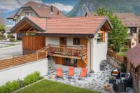 a house with a balcony and orange chairs at Chalet 65bis - OVO Network in Thônes