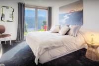 a bedroom with a large bed with a large window at Chalet Kalyssia - OVO Network in Saint-Jorioz