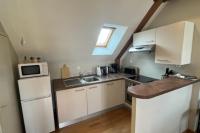 a small kitchen with a sink and a microwave at Bright apartment near the heart of Vannes in Vannes