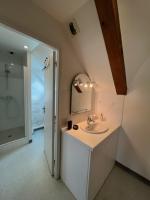 a bathroom with a sink and a mirror at Bright apartment near the heart of Vannes in Vannes