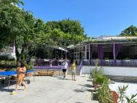 a group of people walking in front of a building at Парк-хотел РИВА in Golden Sands
