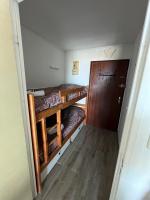 a room with two bunk beds and a door at GROOMI Le Lake City- Studio de plage à Carnon ! in Mauguio