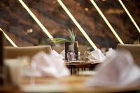 a table in a restaurant with a plant on it at Ramada by Wyndham Istanbul Merter in Istanbul