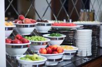 a buffet with bowls of apples and plates of food at Ramada by Wyndham Istanbul Merter in Istanbul
