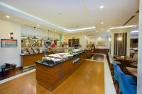 a restaurant with a counter with food on it at Ramada by Wyndham Istanbul Merter in Istanbul