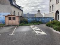 a parking lot with a building and a garage at T2 Le Conquet &quot;Molène&quot; avec parking privé 300m commerces in Le Conquet
