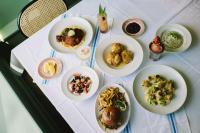 a table with plates of food on a table at Hilton Greenville in Greenville