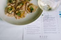 a plate of food on a table with a menu at Hilton Greenville in Greenville