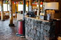 a brick counter in a restaurant with a trash can at Hotel Tambopaxi in Machachi