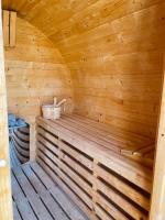 a wooden sauna with a bench in a cabin at Maul - Lator vendégház in Villány