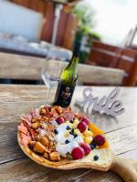 a plate of food on a table with a bottle of wine at Maul - Lator vendégház in Villány