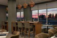 uma sala de jantar com uma mesa longa e cadeiras em Embassy Suites By Hilton Montreal Airport em Pointe-Claire