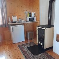 a kitchen with a stove and a refrigerator at Kellerstöckl Maierjörgl in Sankt Martin im Sulmtal