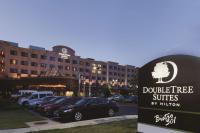 a sign in front of a hotel with cars parked in a parking lot at DoubleTree Suites by Hilton Bentonville in Bentonville