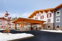 a rendering of the front of a hotel in the snow at Hampton Inn &amp; Suites Leavenworth in Leavenworth