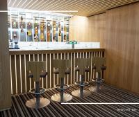a bar with four chairs in front of a counter at Hotel Kamzík *** in Malá Morávka