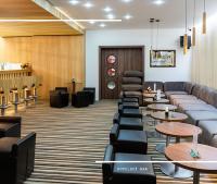 a waiting room with couches and tables at Hotel Kamzík *** in Malá Morávka