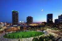 a city skyline at night with a green park at Hilton St. Louis at the Ballpark in Saint Louis