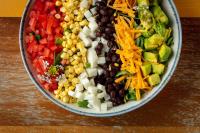 eine Schüssel Salat mit Bohnen, Mais und Gemüse in der Unterkunft The Waterfront Beach Resort, A Hilton Hotel in Huntington Beach
