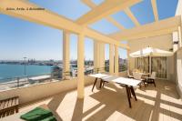 a balcony with a table and a view of the water at Plaza Mina Suites - Adults Recommended by Luxury Suites Cadiz in Cádiz