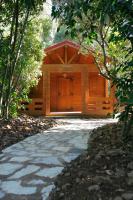 a wooden cabin with a walkway in front of it at Complejo Rural Huerta Grande in Algeciras