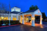 Una casa blanca con un mirador por la noche en Hilton Garden Inn Livermore, en Livermore