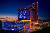 ein großes Gebäude mit blauen Lichtern in der Nacht in der Unterkunft Crockfords Las Vegas, LXR Hotels &amp; Resorts at Resorts World in Las Vegas