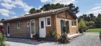 a small wooden cabin with a white door at MAISON &amp; PISCINE PRIVES,PLAGES OCEAN ET LAC A 10 kms in Linxe