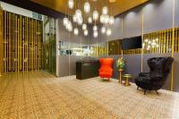 a lobby with two chairs and a television in a building at Gran Hotel Costa Rica, Curio Collection By Hilton in San José